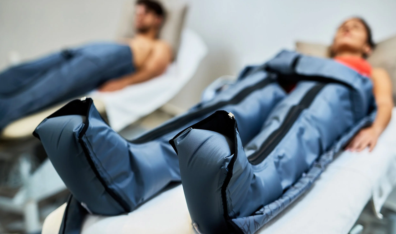 Person receiving pressotherapy treatment with compression garments